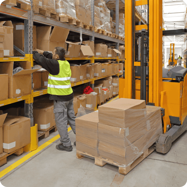 Worker stocking boxes in warehouse.